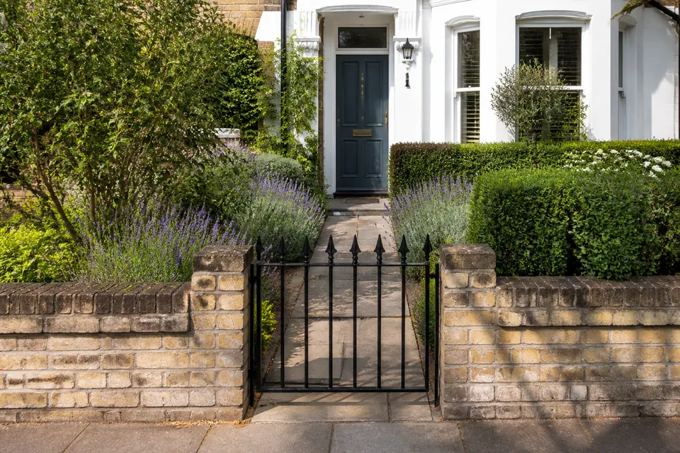 Illustrative planted front garden beside a home