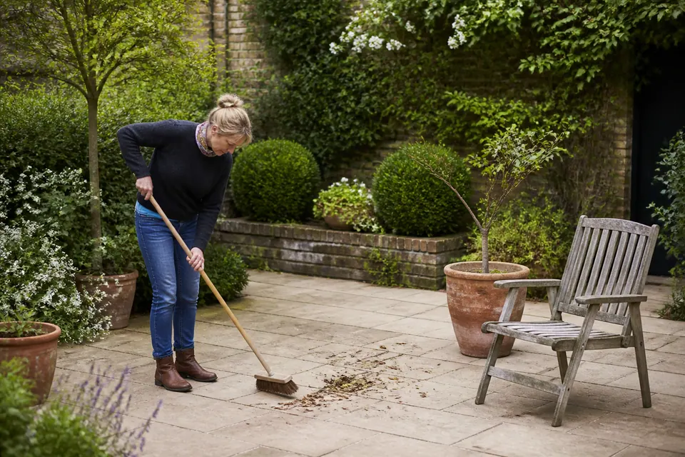 Illustrative tidying beside garden paving